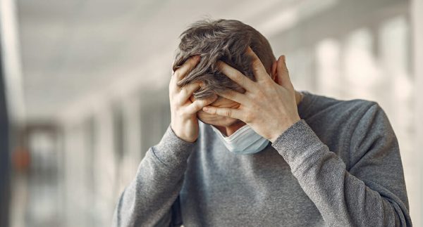 Man in a mask standing in the hall of hospital